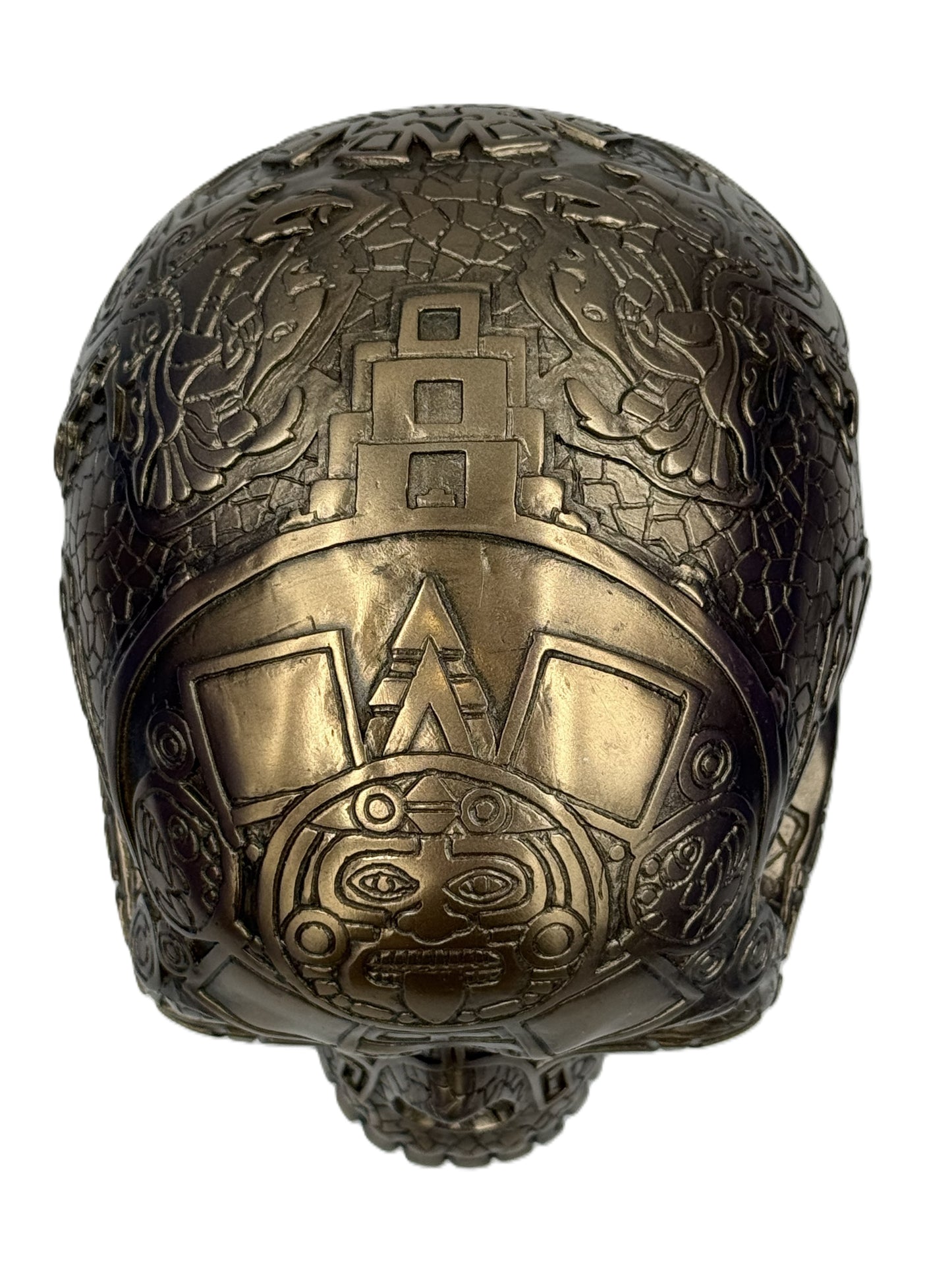 Top view of Aztec bronze skull showing engraved patterns and central tribal motif