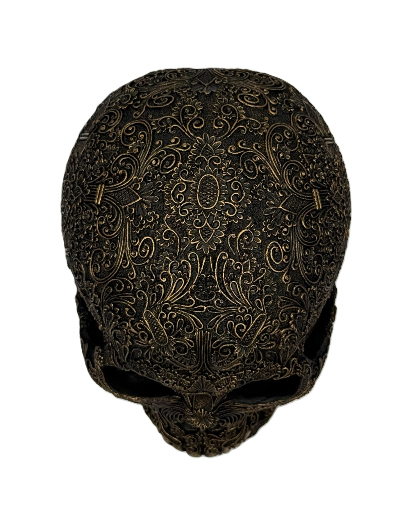 Straight front view of ornate gothic skull sculpture with symmetrical engraved design and aged finish