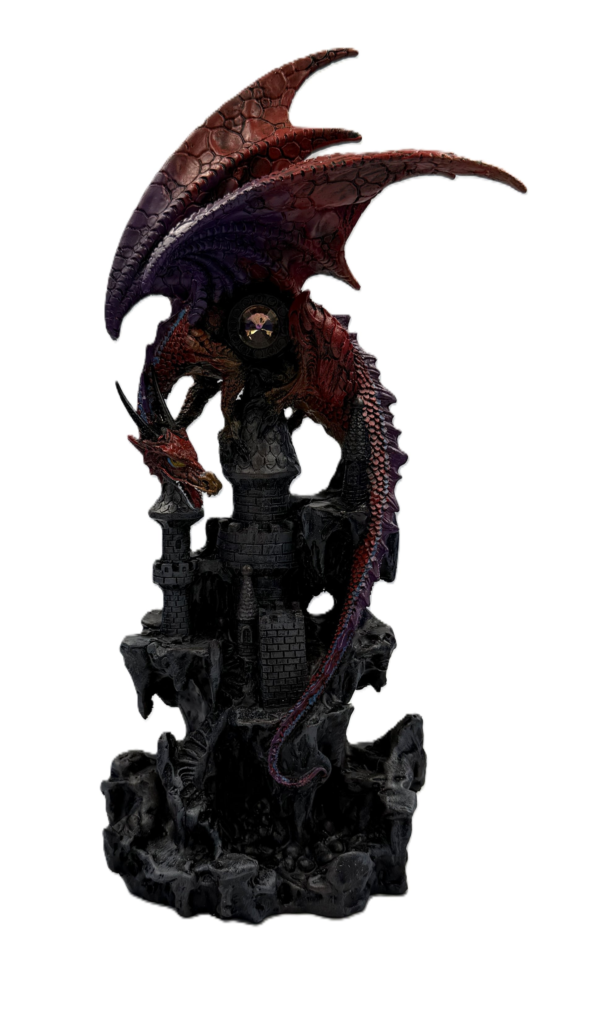 Front view of red dragon statue perched on castle tower with detailed scales and gothic fortress base
