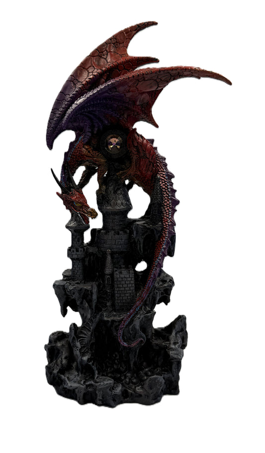Front view of red dragon statue perched on castle tower with detailed scales and gothic fortress base
