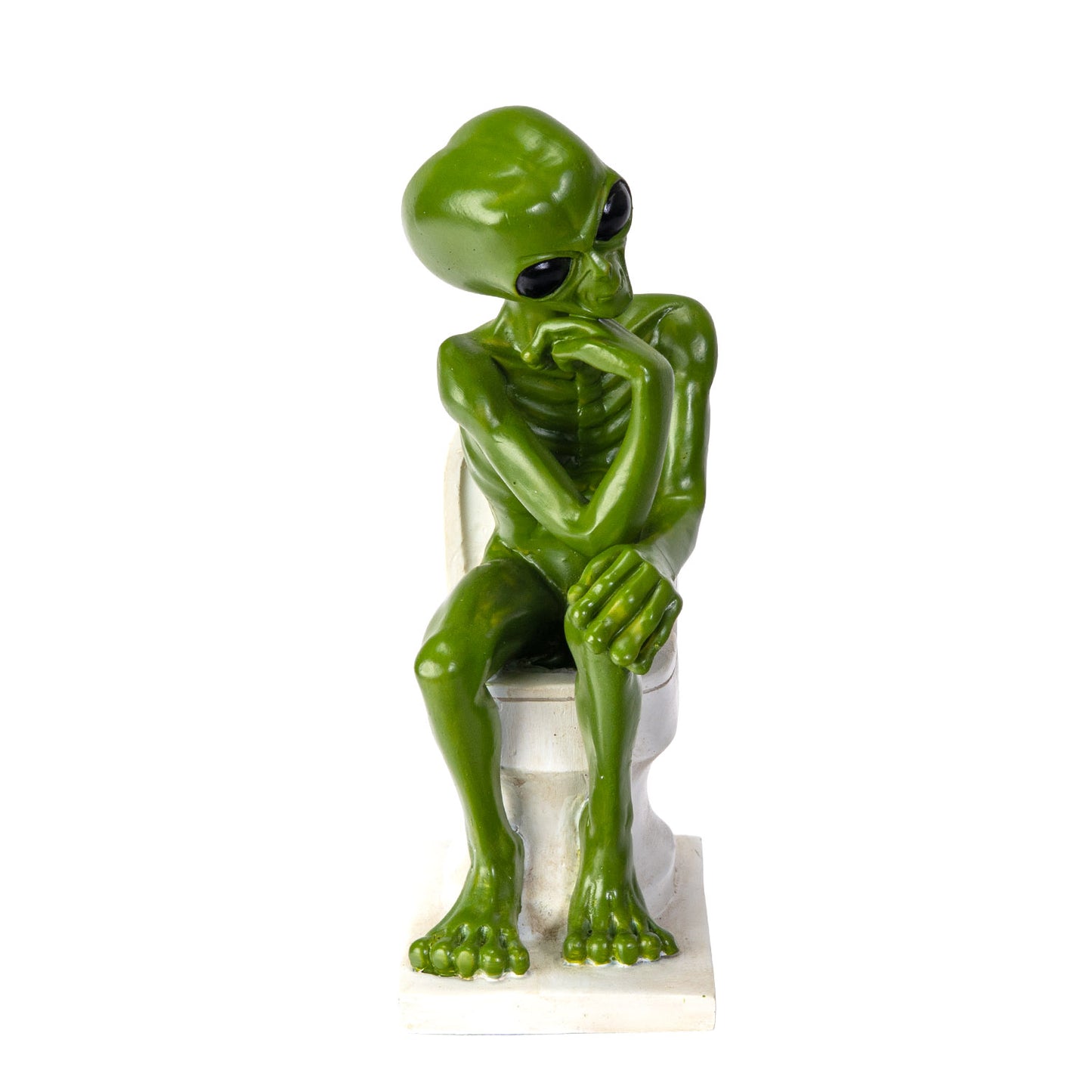 Front view of alien figurine sitting on toilet with hands resting

