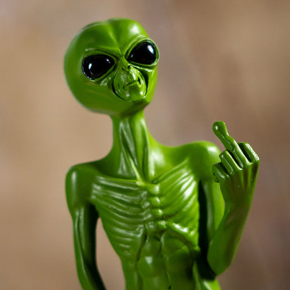 Close up of alien face and hand gesture with glossy eyes
