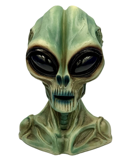 Front view of alien head statue with large glossy eyes and detailed sculpting
