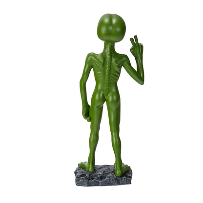 Back view of alien statue showing body details and pose

