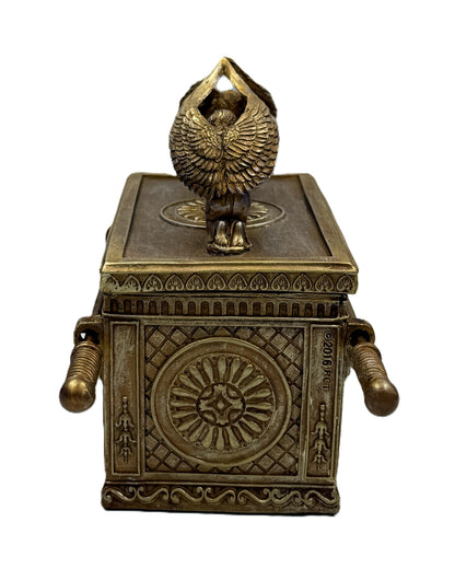 End view of Ark of the Covenant box showing detailed circular emblem and textured design

