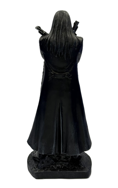 Back view of grim reaper statue with long flowing coat and detailed sculpting
