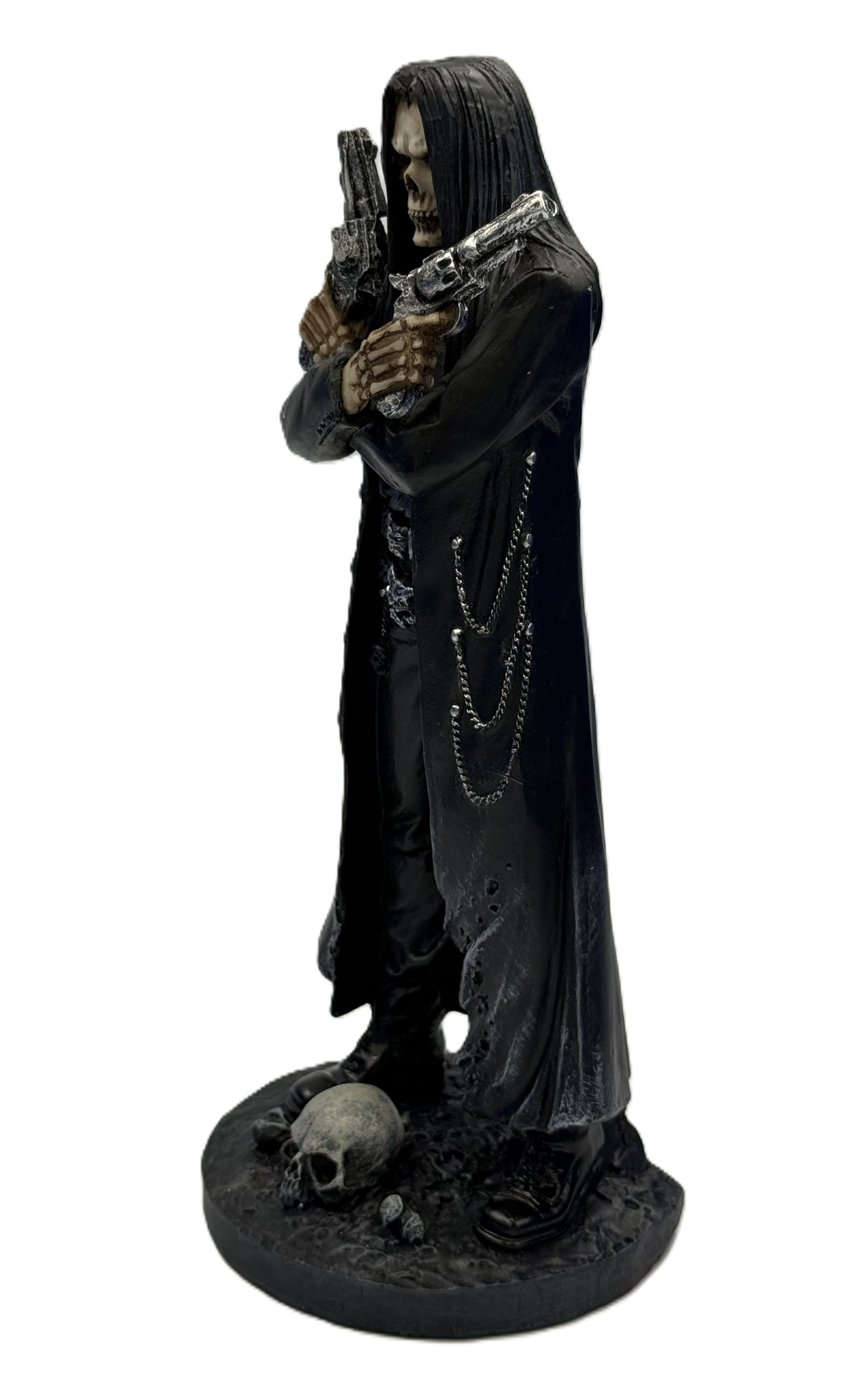 Side view of gothic grim reaper assassin statue showing long coat chains and dual pistols
