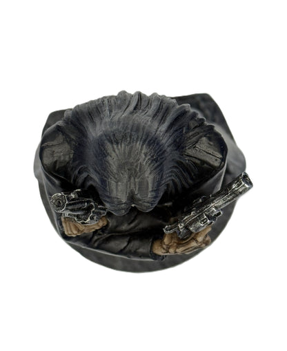 Top view of grim reaper statue showing hair detail and dual pistols from above
