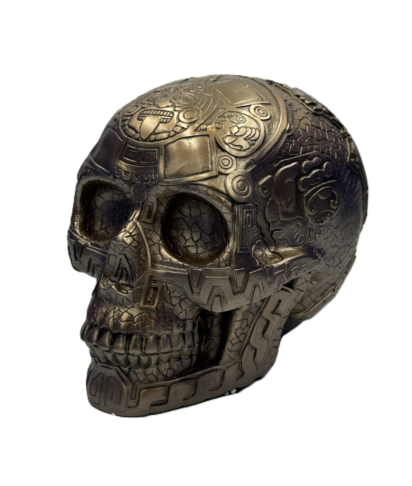 Front angled view of Aztec bronze skull statue with intricate tribal carvings and textured finish
