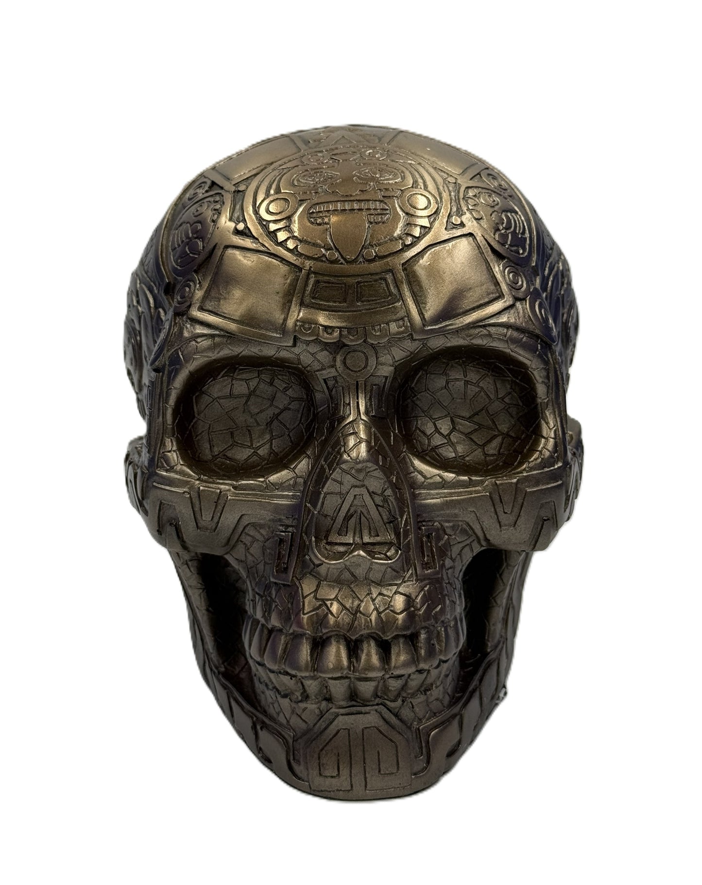 Front view of Aztec skull statue showing detailed face carvings and tribal design elements
