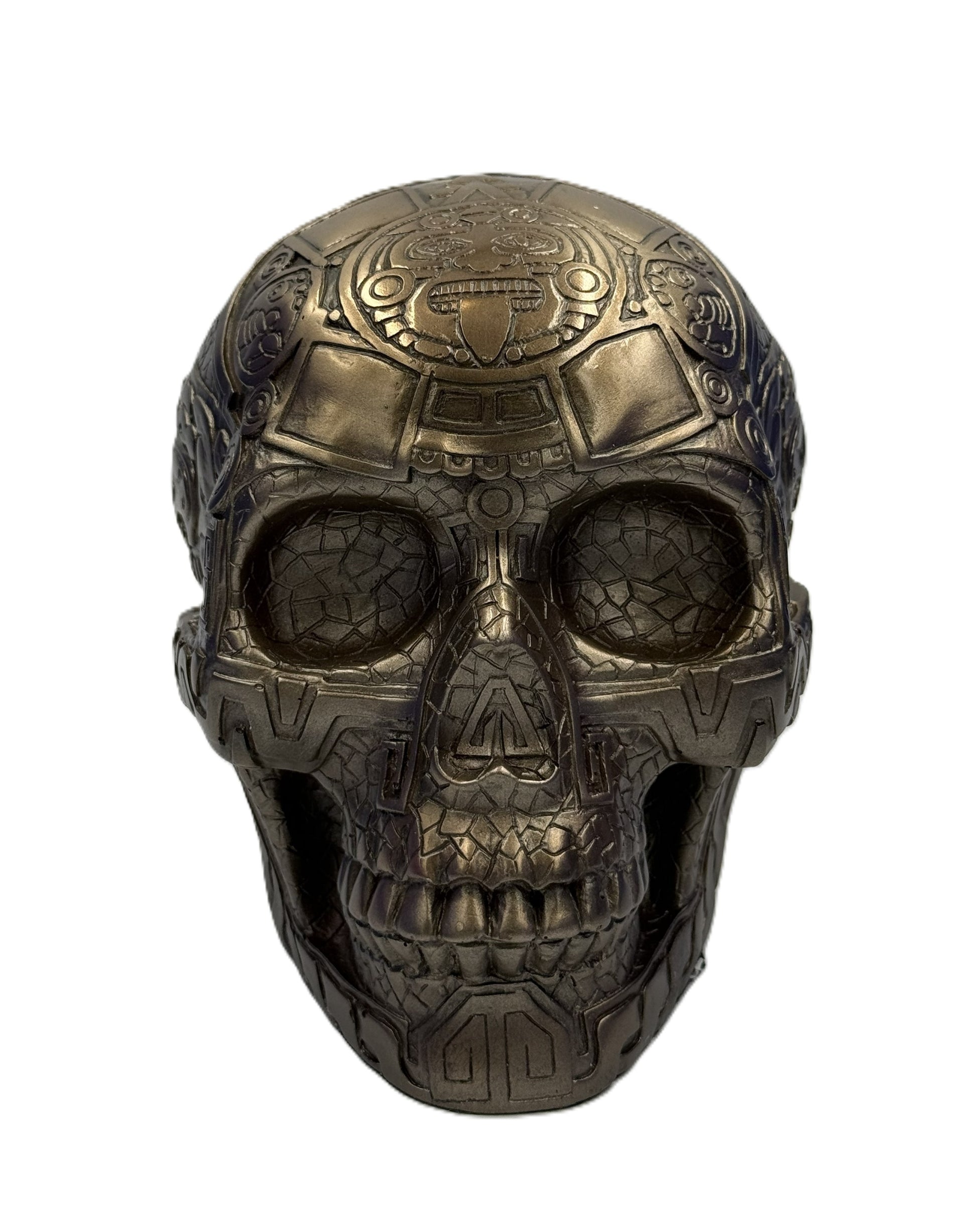 Front view of Aztec skull statue showing detailed face carvings and tribal design elements
