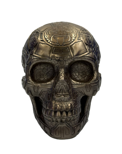 Front view of Aztec skull statue showing detailed face carvings and tribal design elements
