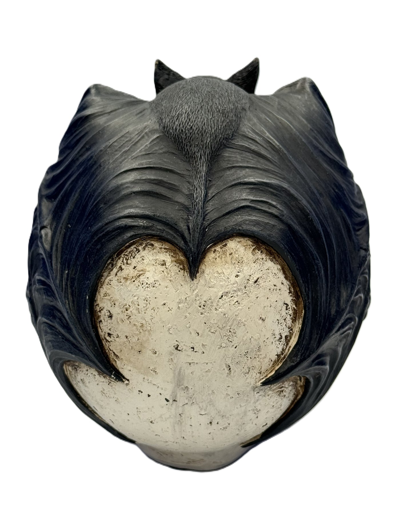 Back view of bat skull statue highlighting wing texture and sculpted surface details

