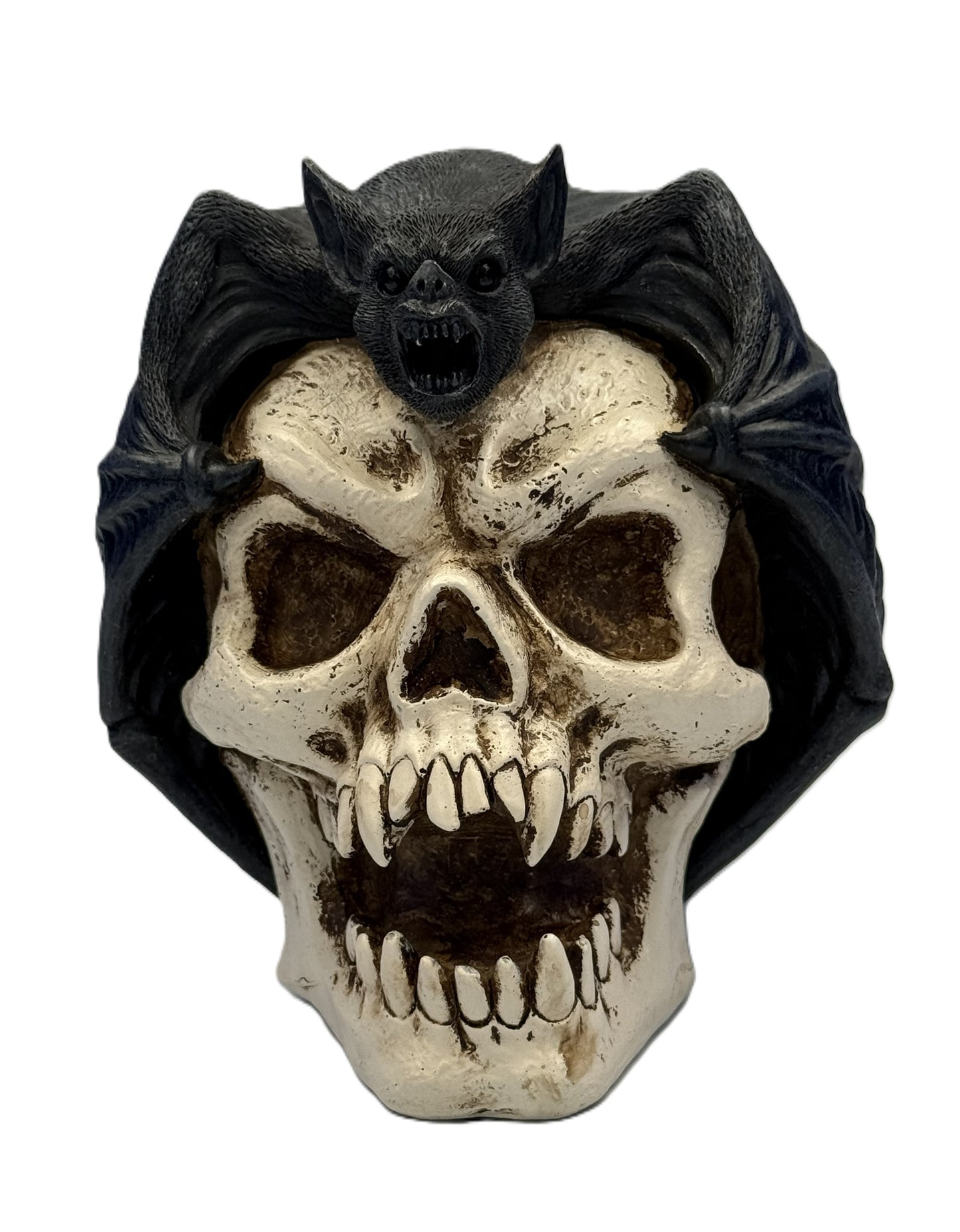 Front view of gothic bat perched on skull statue with wings spread and distressed bone detailing
