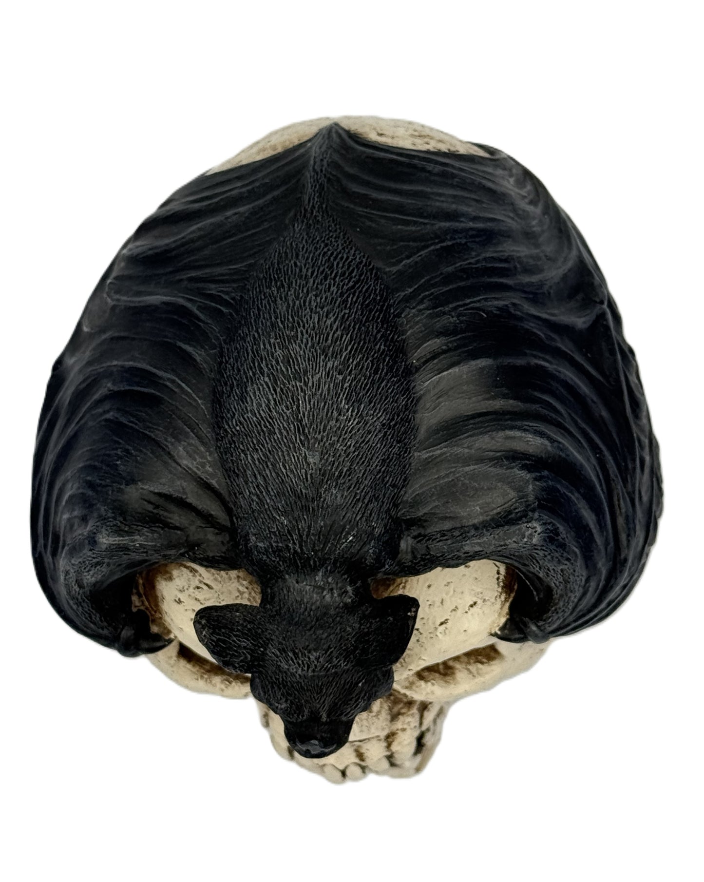 Top view of bat skull statue showing full wing span and positioning over skull
