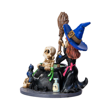 Right angle view of gothic witch figurine with potion bottle and cauldron scene
