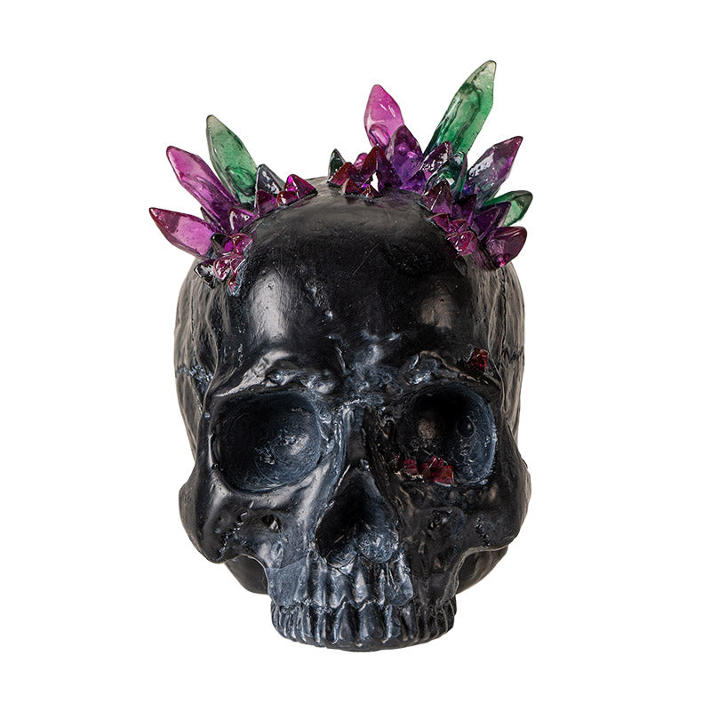 Front view of black skull with vibrant pink and green crystal accents
