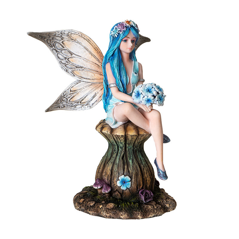 Angled front view of fairy statue on mushroom showing facial expression and dress details
