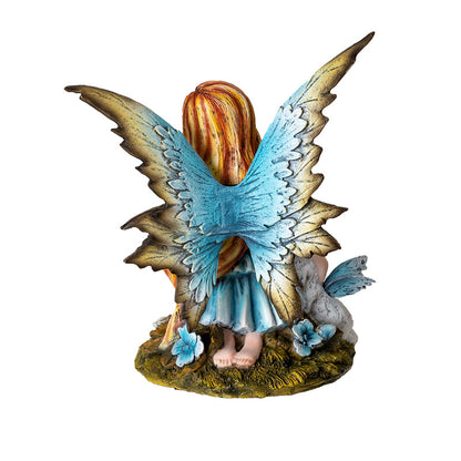 Back view of fairy figurine showing detailed blue wings and flowing hair
