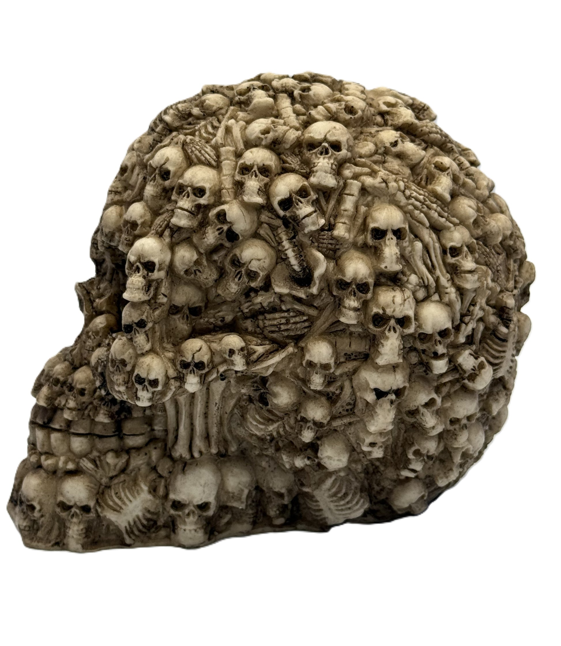 Side view of gothic skull statue featuring layered small skulls and skeletal details forming a large skull shape
