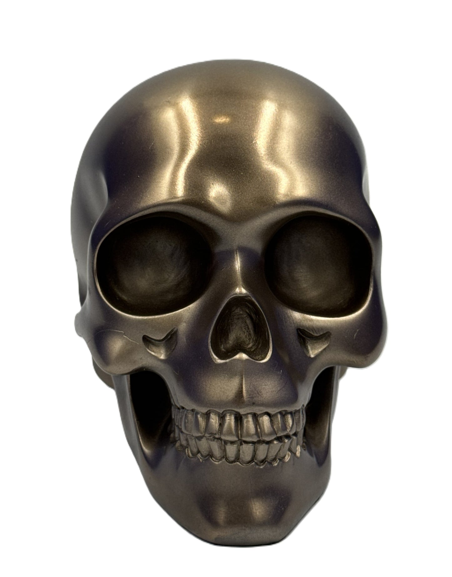 Front view of bronze skull decor with hollow eye sockets and detailed teeth structure
