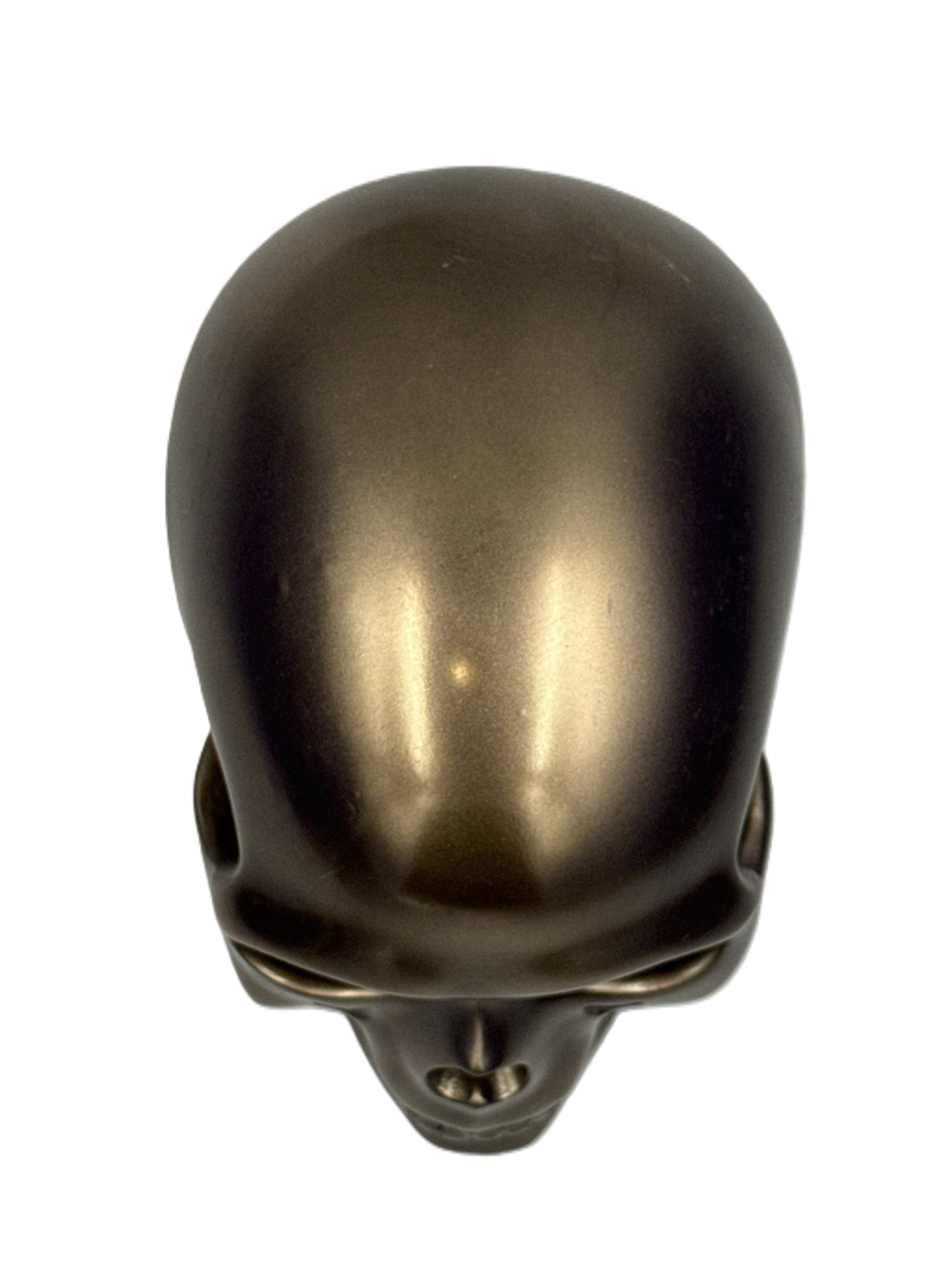 Top view of bronze skull sculpture showing smooth curvature and polished finish

