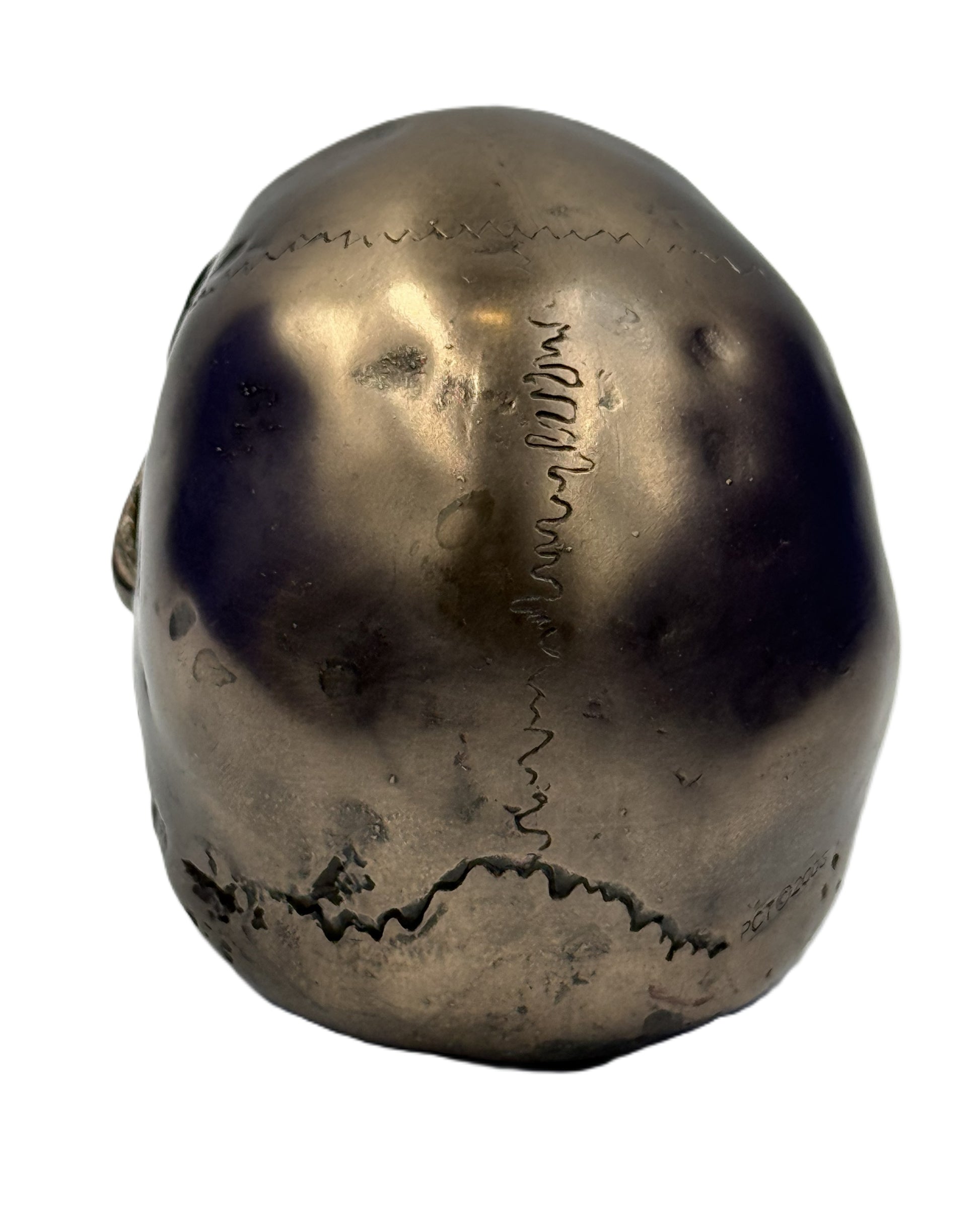 Back view of bronze skull statue showing textured surface cracks and antique finish gothic decor piece
