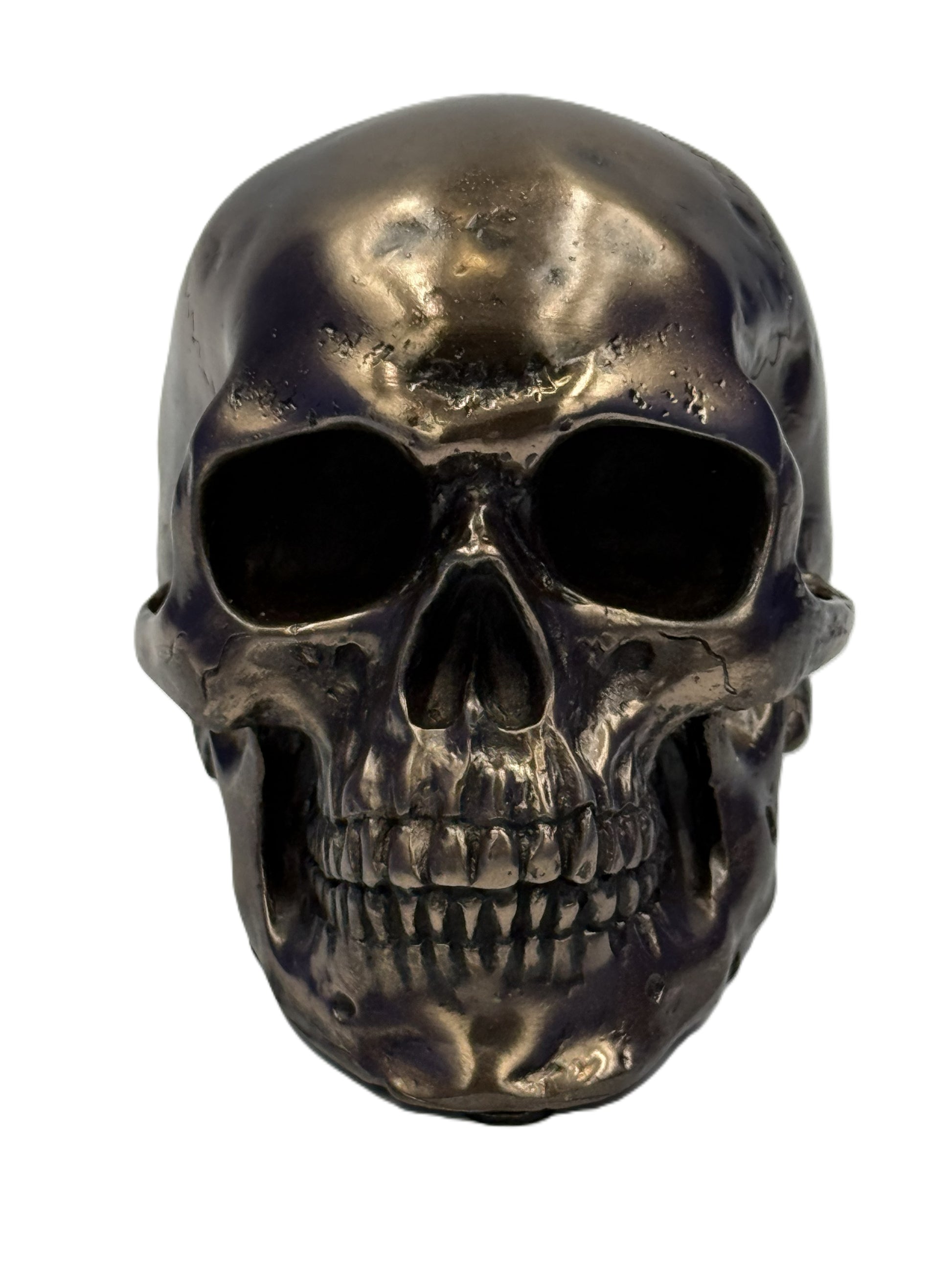 Front view of small bronze skull statue with hollow eyes and detailed teeth gothic decor collectible
