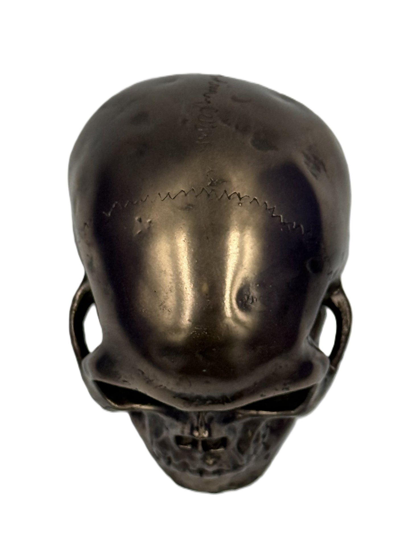 Top view of bronze skull figurine showing surface texture and aged patina finish gothic collectible
