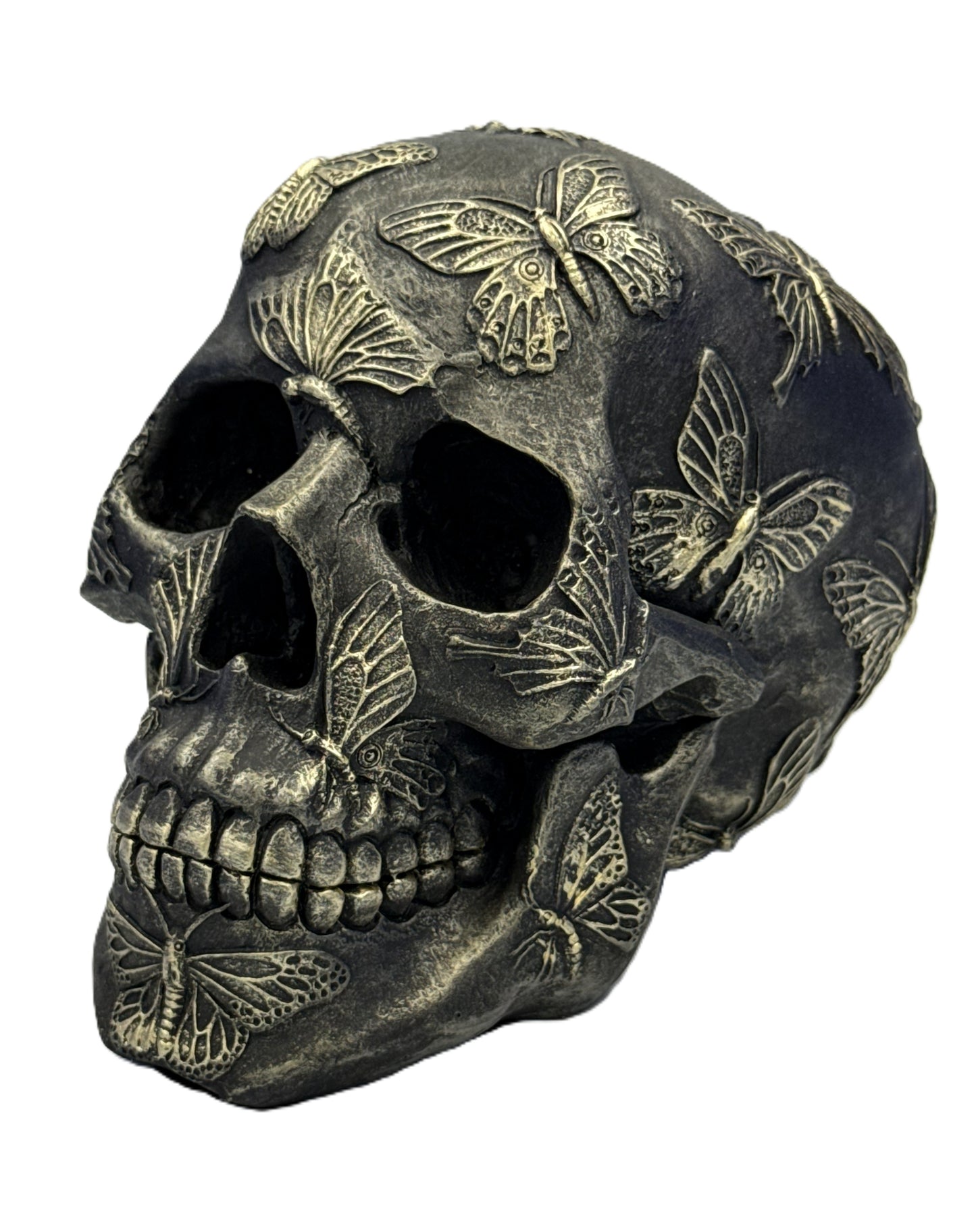 Angled left view of butterfly skull decor showing intricate butterfly wing carvings and textured finish
