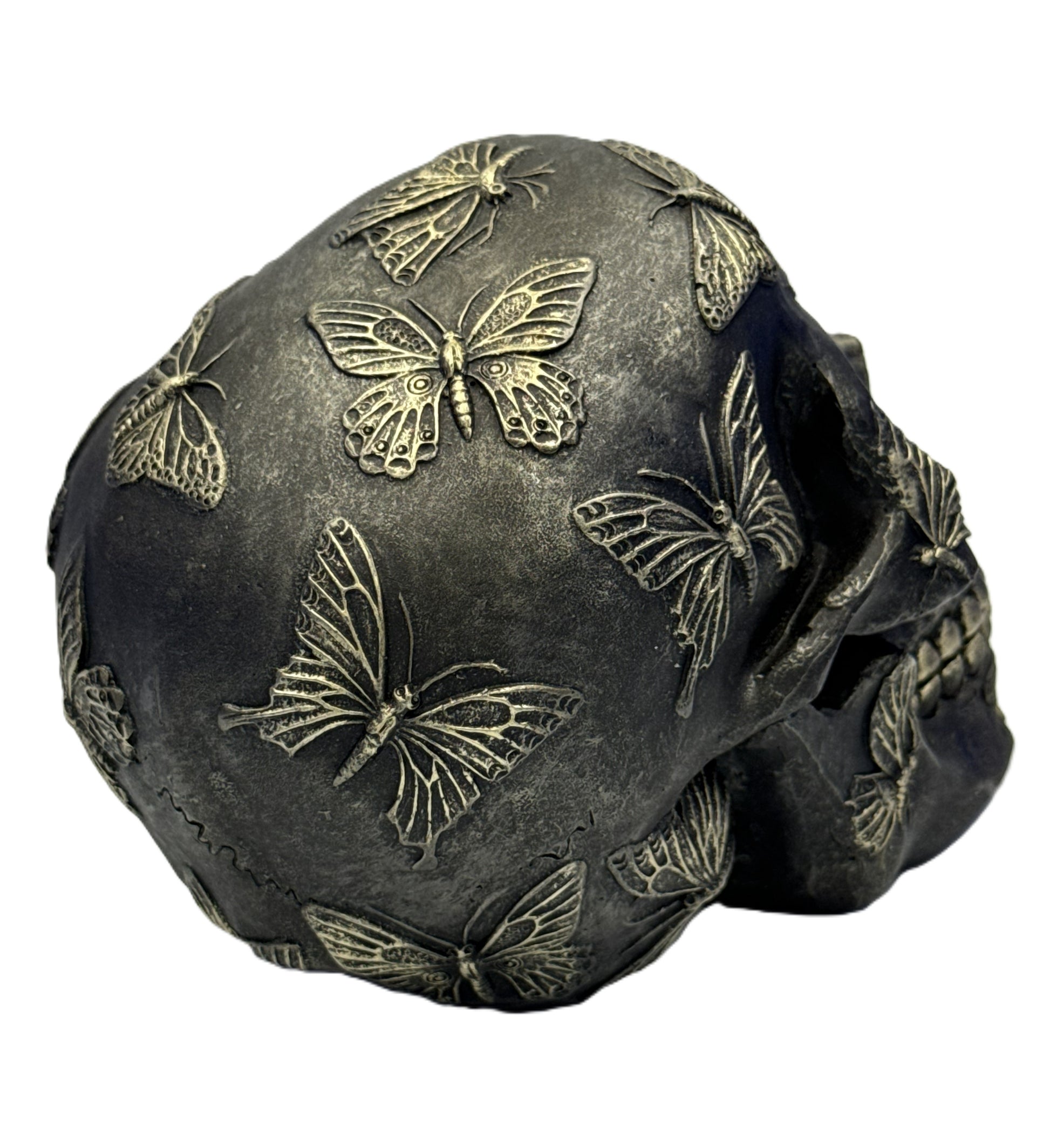 Left side angle of butterfly skull collectible highlighting sculpted butterfly patterns and depth

