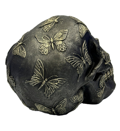 Left side angle of butterfly skull collectible highlighting sculpted butterfly patterns and depth
