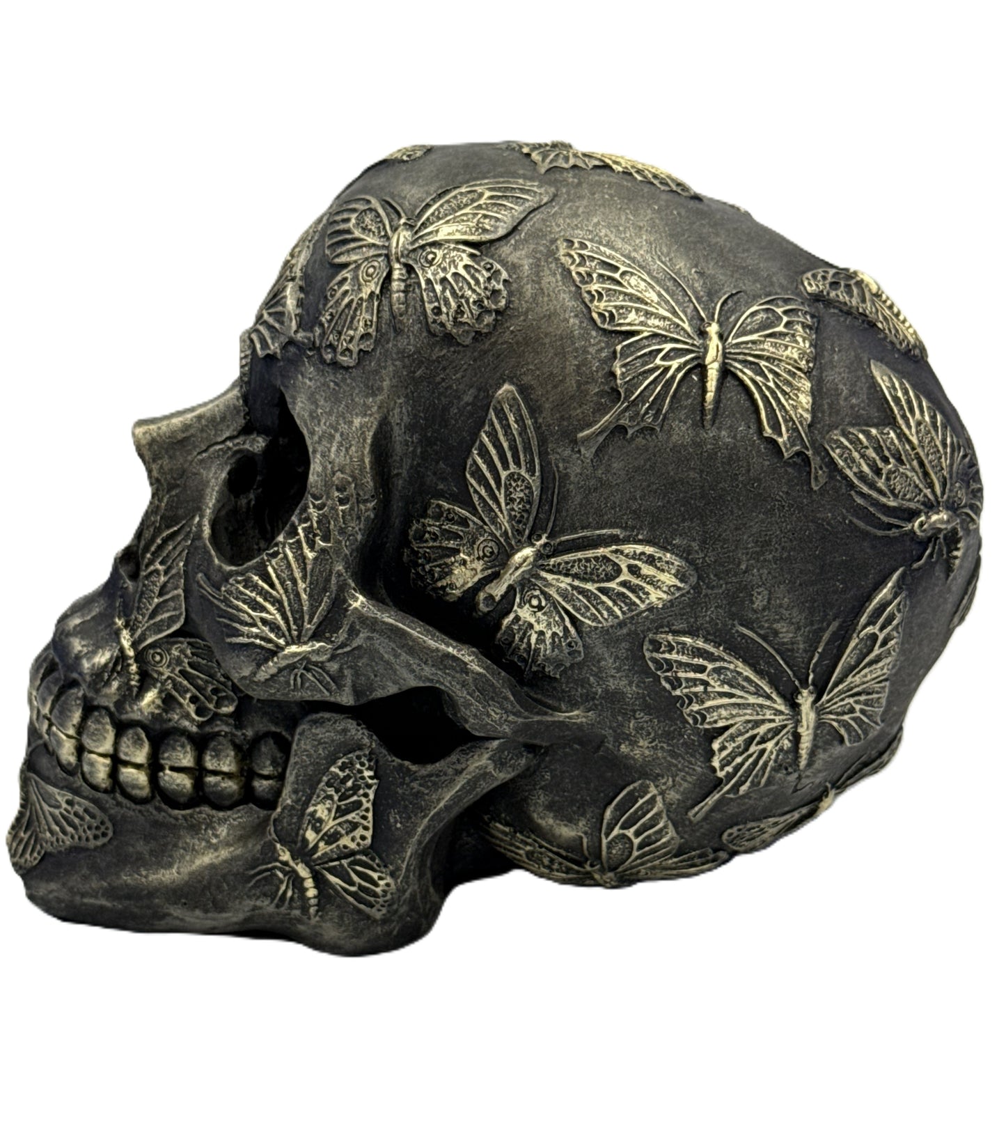 Right side view of decorative skull with raised butterfly details and dark antique finish
