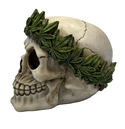 Left side view of resin skull decor featuring textured cannabis leaves wrapped around the crown
