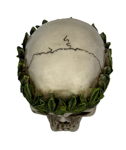 Top back view of skull sculpture highlighting leaf crown arrangement and cracked bone texture
