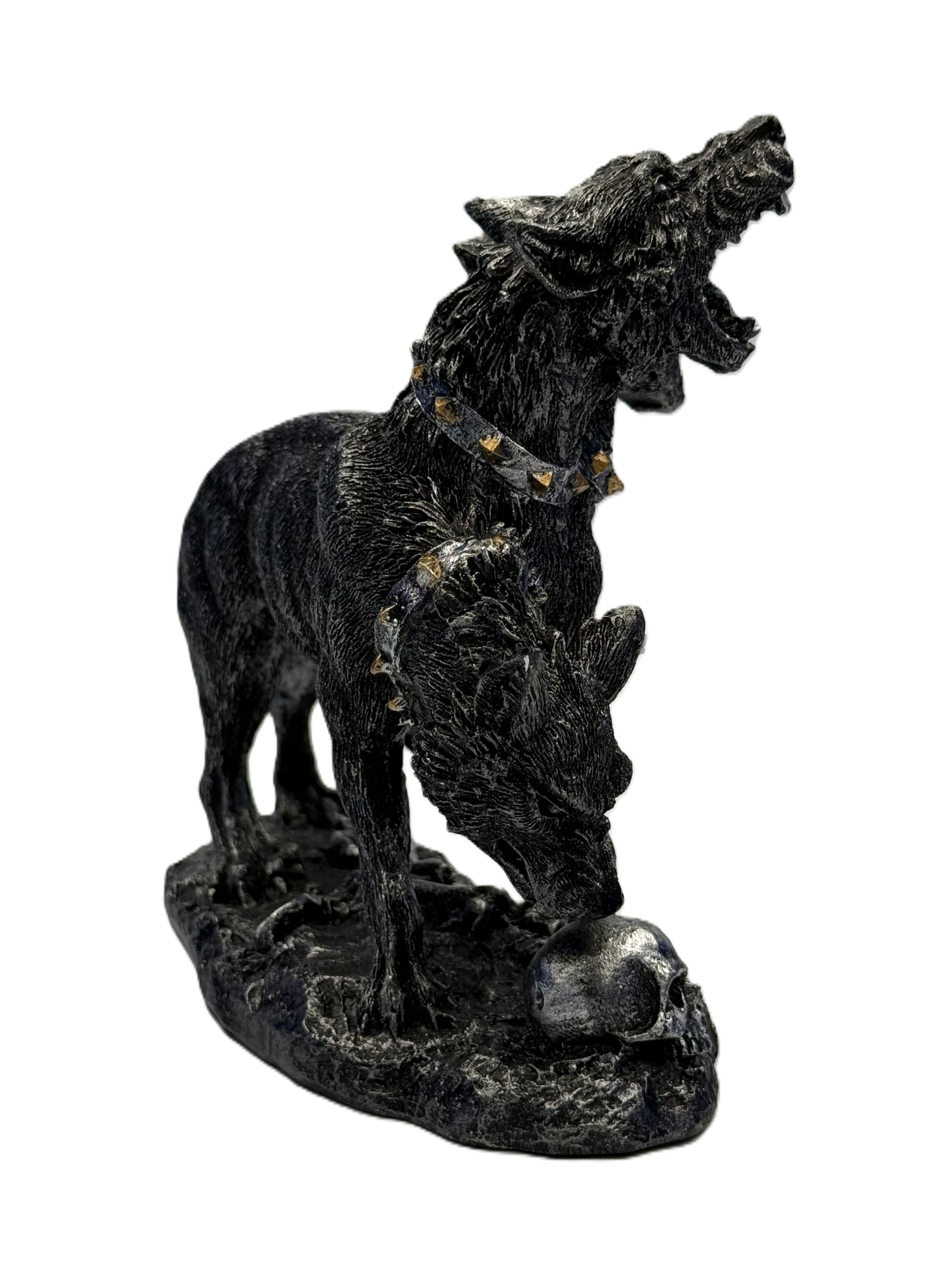 Front right angled view of Cerberus sculpture with snarling heads open jaws and skull detail on base
