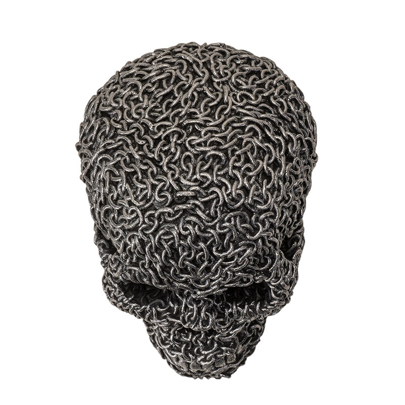 Top view of gothic chain skull sculpture highlighting dense chain pattern

