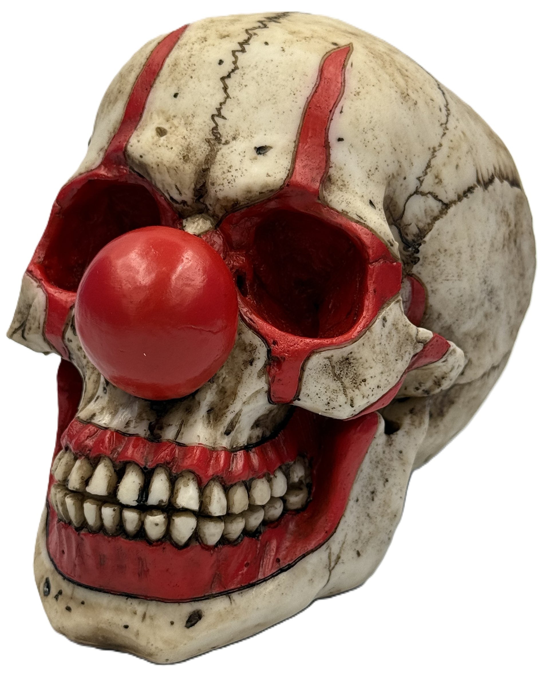 Front angled view of hand painted clown skull statue with red nose and distressed horror detailing resin decor
