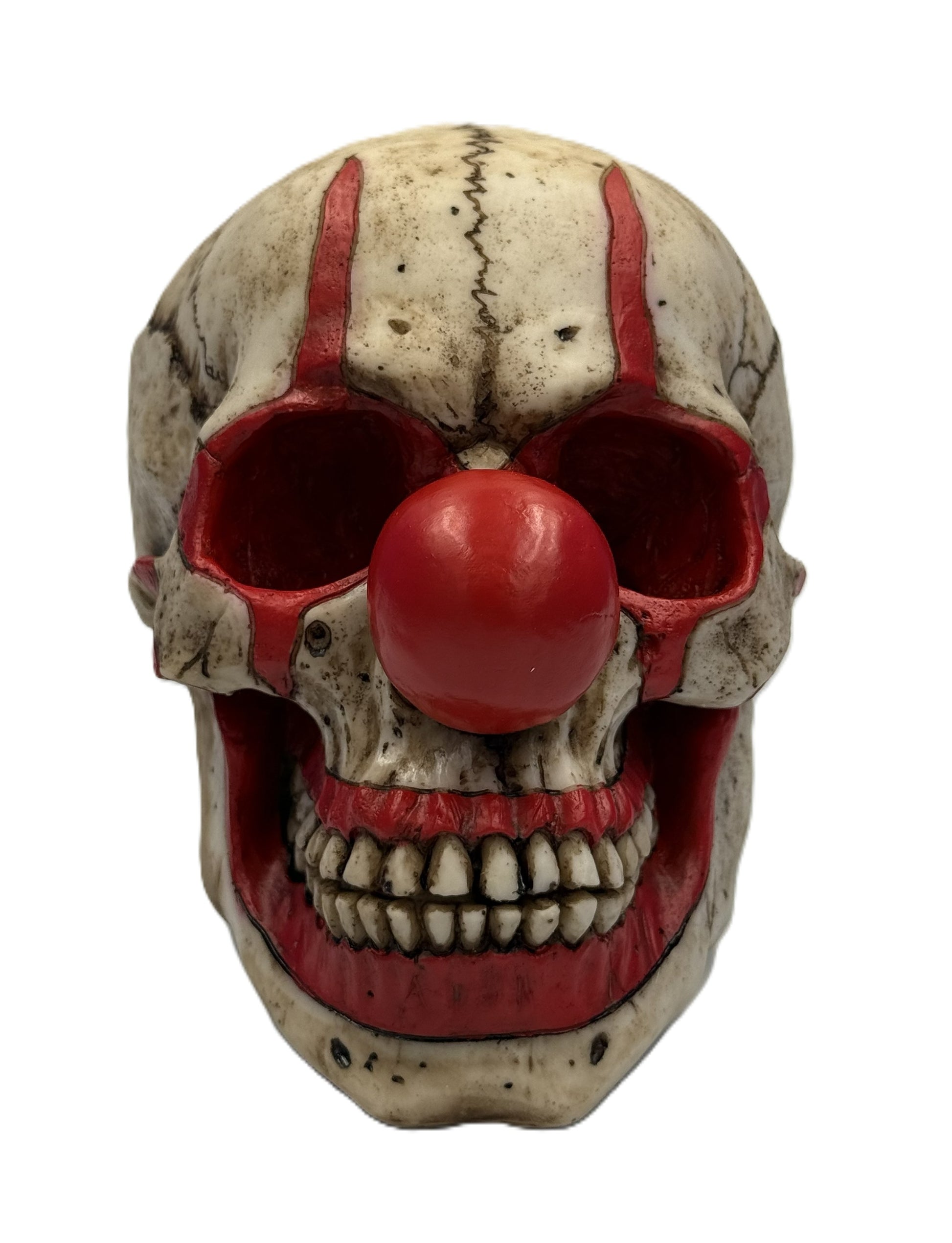 Front view of creepy clown skull statue with red nose hollow eyes and detailed teeth horror collectible
