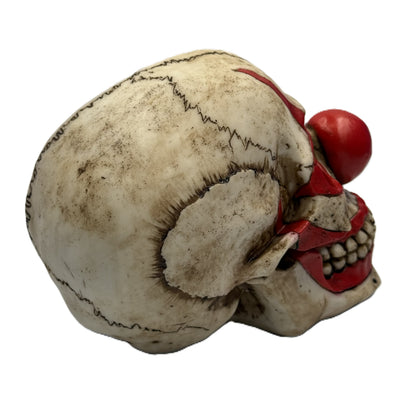 Rear side angle of clown skull figurine highlighting textured skull surface and stitched seam details
