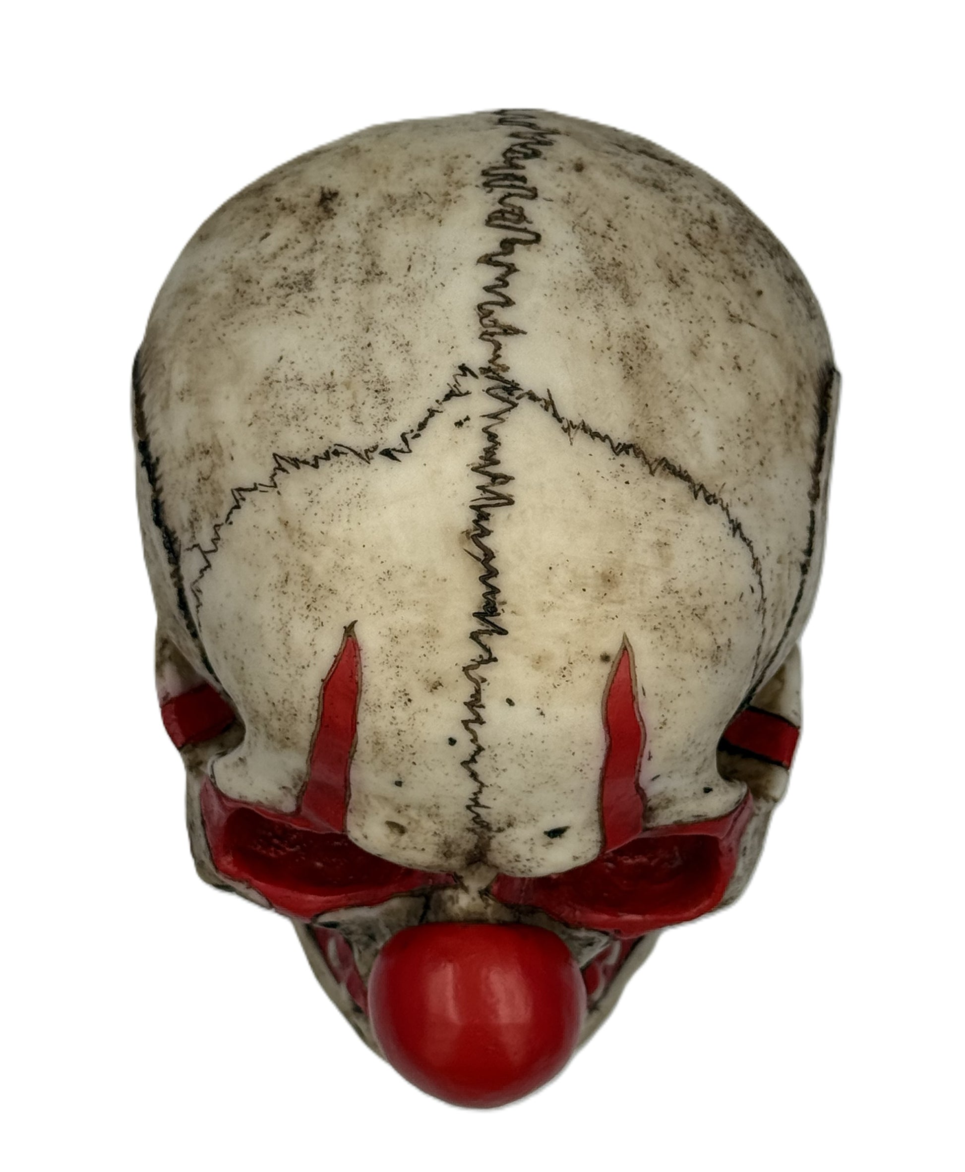 Top view of clown skull statue showing stitched design across skull and weathered antique finish
