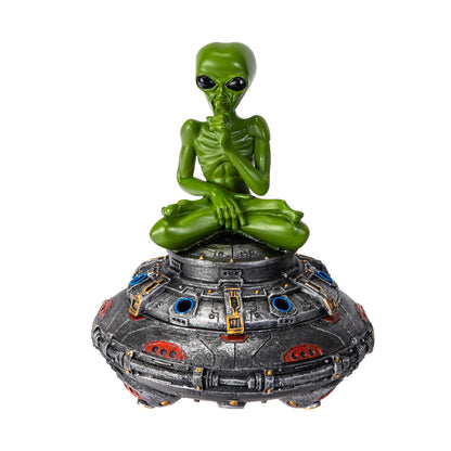 Front view of green alien meditating on UFO incense burner
