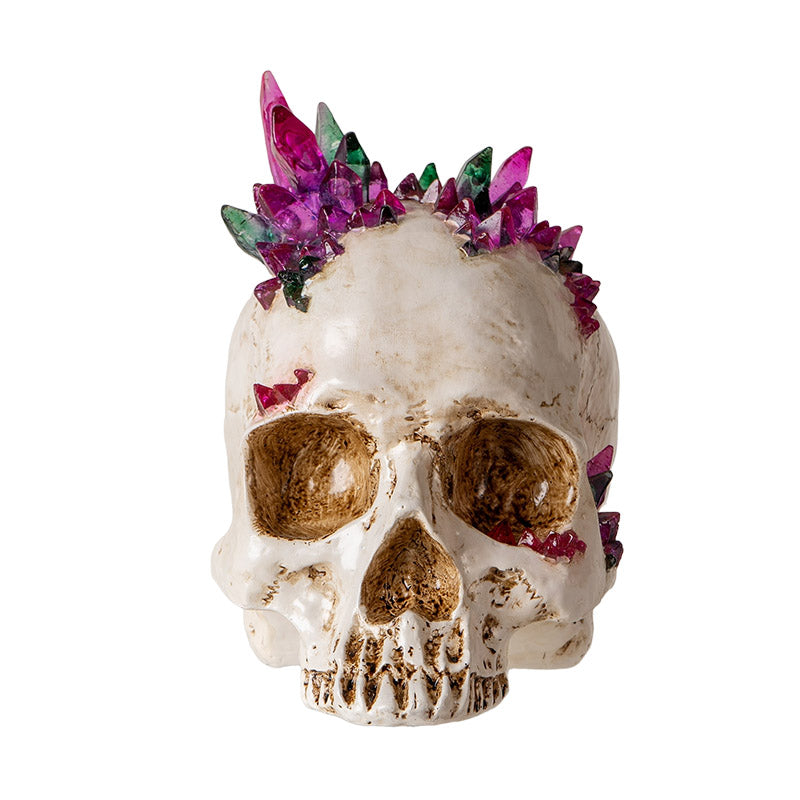 Front view of skull with vibrant pink and green crystal accents
