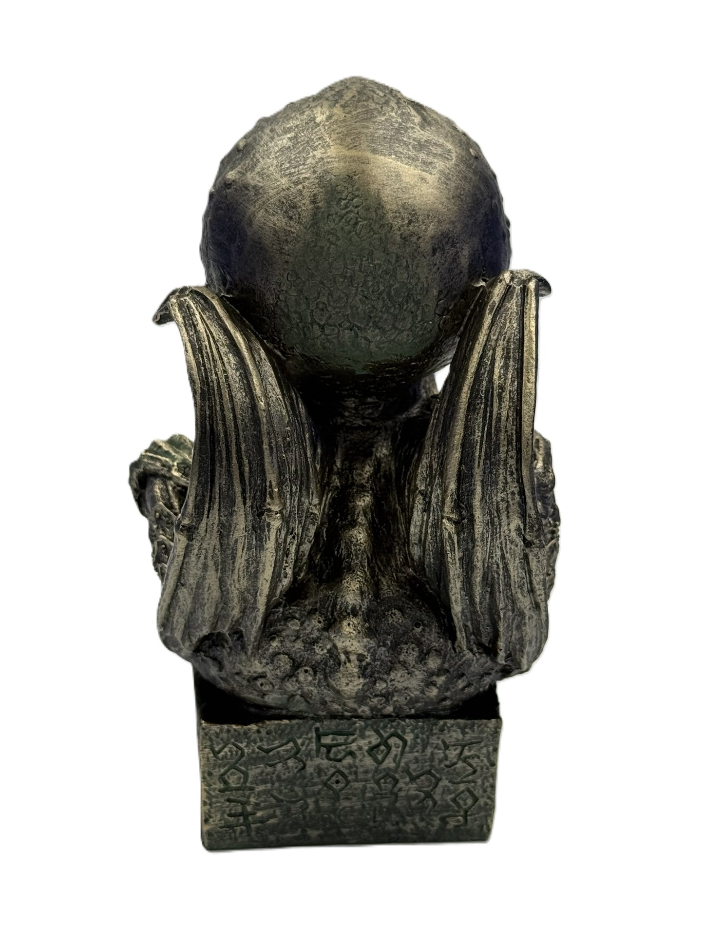 Back view of Cthulhu statue with wings extended textured surface and engraved base details
