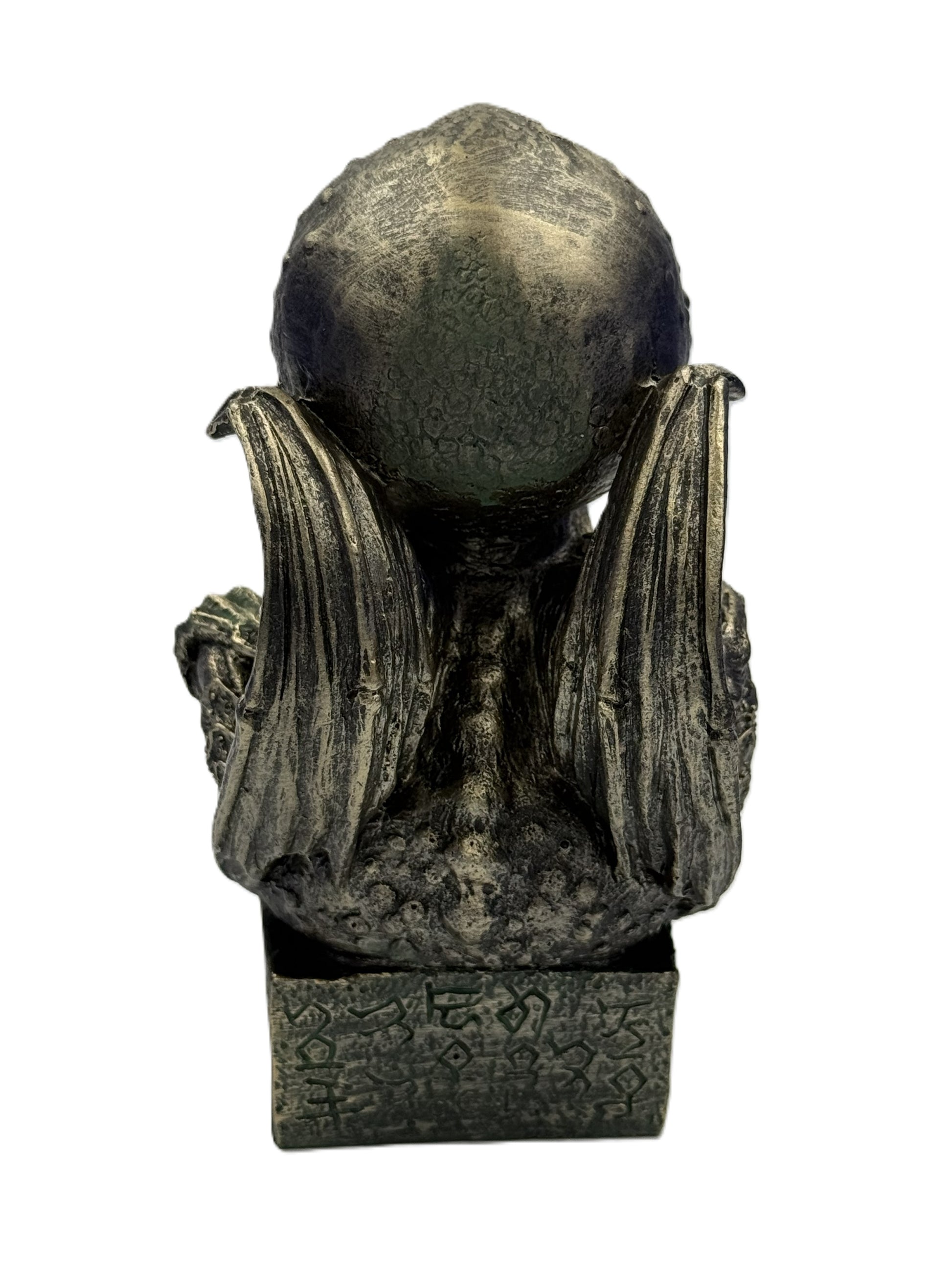 Back view of Cthulhu statue with wings extended textured surface and engraved base details
