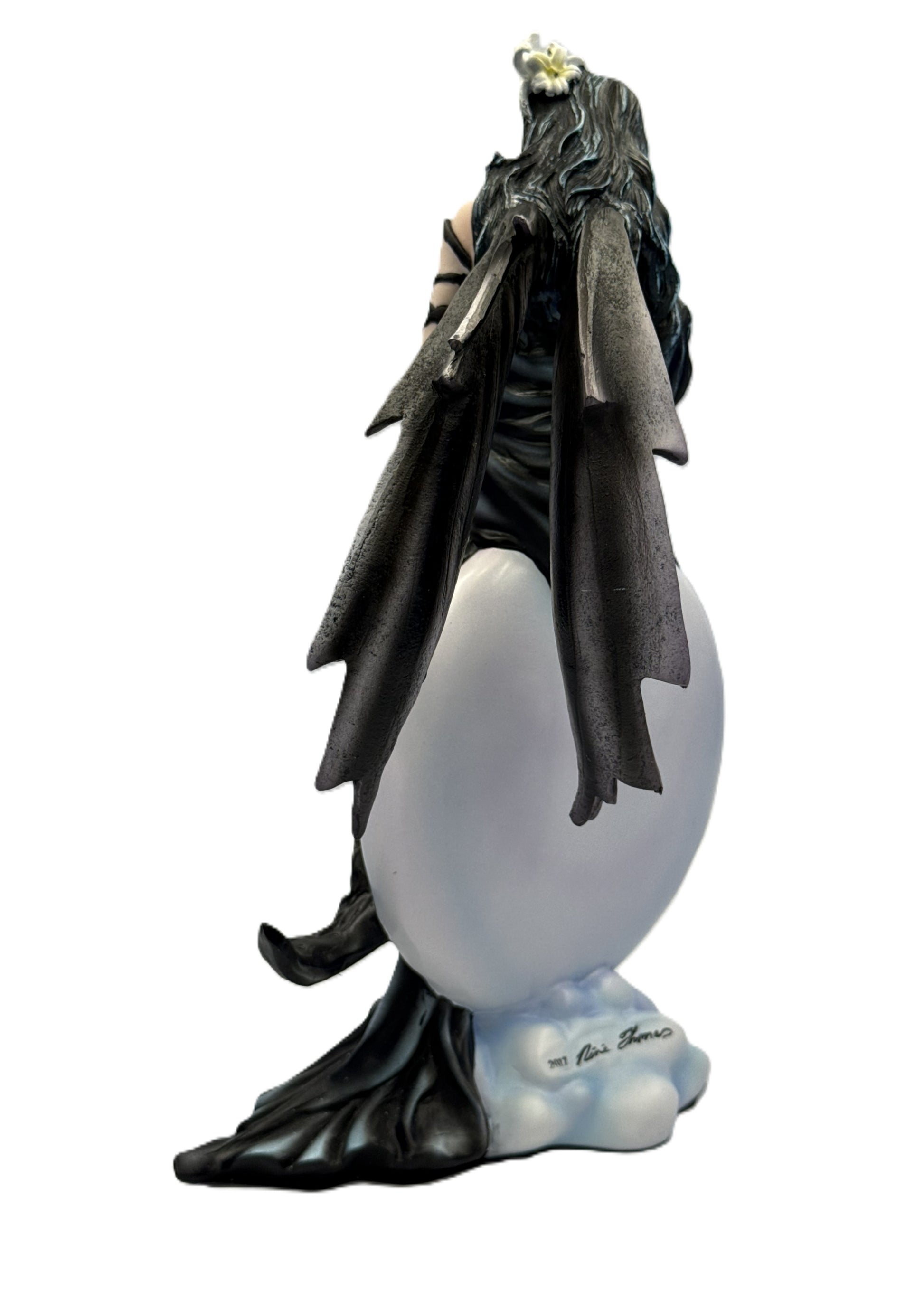 Back view of fairy statue highlighting textured wings, long flowing hair, and sculpted orb base
