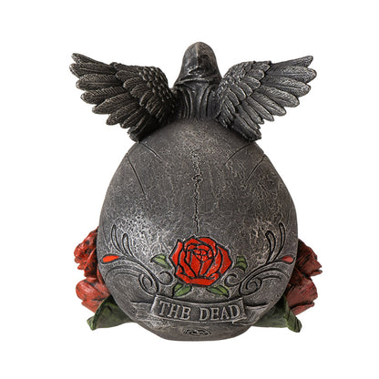 Back view of gothic skull statue showing wings and rose detailing with text the dead

