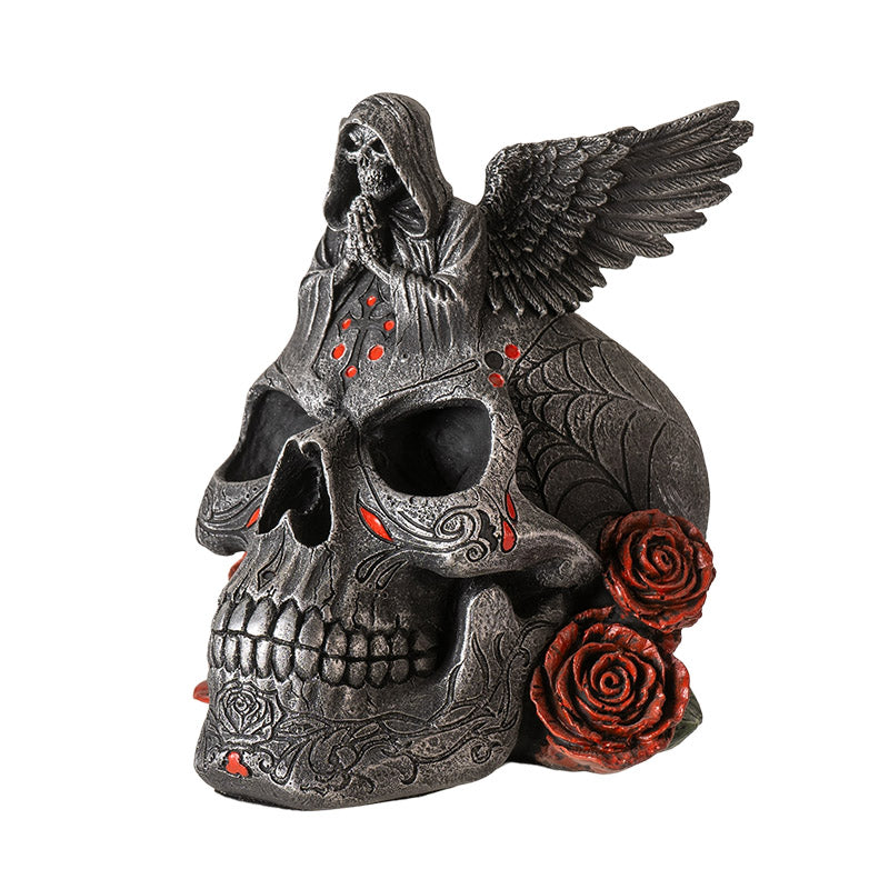 Side view of winged skull statue with roses and detailed textures
