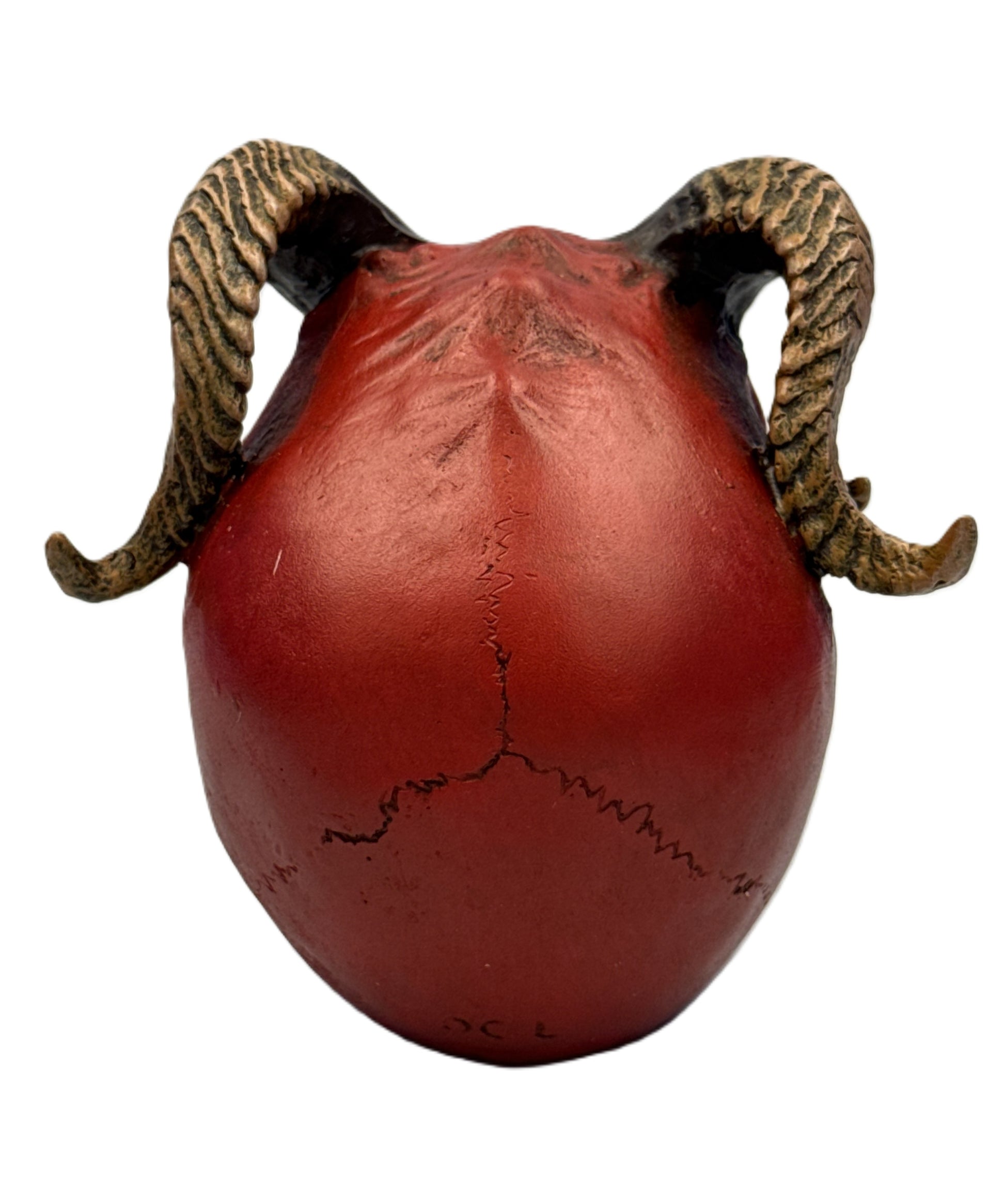 Back view of demon skull statue featuring smooth rounded shape with crack detailing and curved horns
