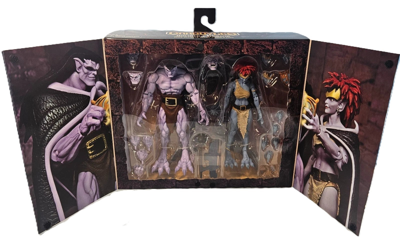Opened display packaging for Disney Gargoyles Goliath and Demona Ultimate action figure set with accessories visible

